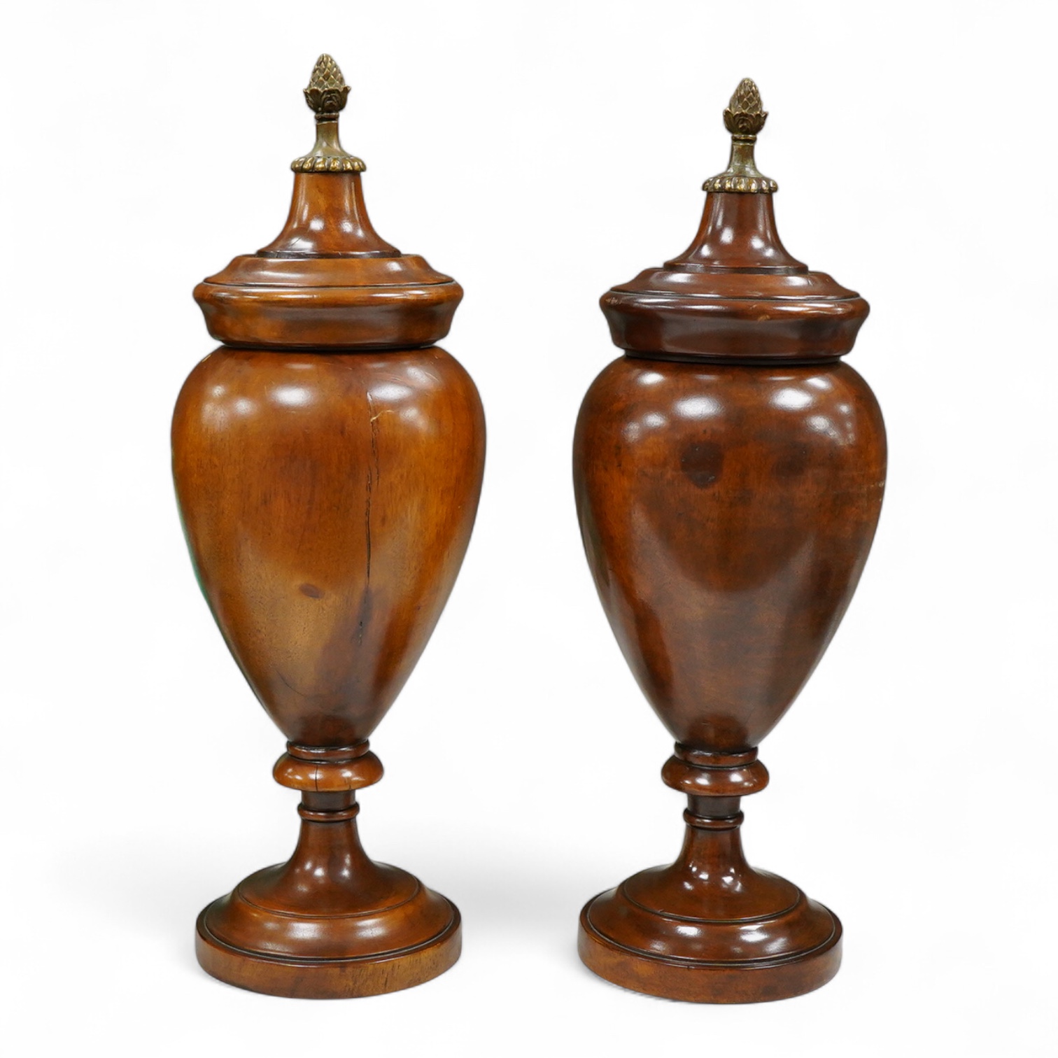 A pair of turned hardwood urns and covers, 42cm
